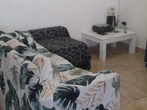 a living room with a couch and a table at ENCANTO SERRANO in Villa Carlos Paz