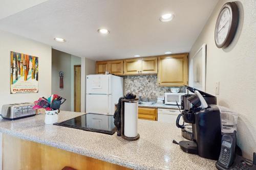 a kitchen with a counter top with a refrigerator at Cascade 347 in Durango Mountain Resort