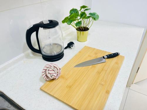 a kitchen counter with a cutting board and a knife at SUNWAY CITRINE-Citrine Hub Max6pax Walk 5min Sunway International School in Iskandar Puteri