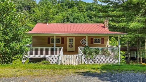 a small wooden house with a red roof at 2Bd Riverfront with Expansive Outdoor Space, River Access, Fire Pit in Crumpler