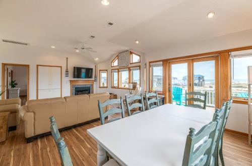 a dining room and living room with a table and chairs at Ocean Aire in Knotts Island