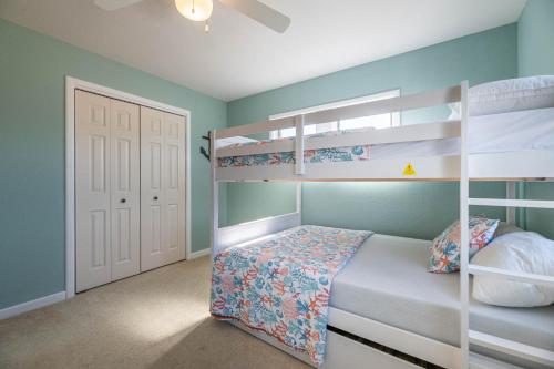 a bedroom with two bunk beds and a white door at Ocean Aire in Knotts Island