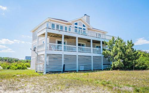 a house sitting on top of a grass field at Ocean Aire in Knotts Island