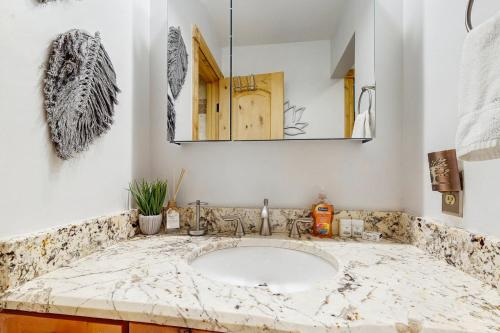 a bathroom with a sink and a mirror at Hi Country Haus 14-5 in Winter Park
