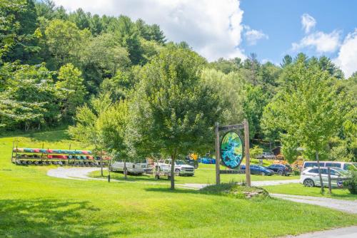 a park with cars parked in the grass at Cabin on New River, Fire Pit, Dogs OK, Hot Tub with VIEWS - Sleeps 10 in Piney Creek