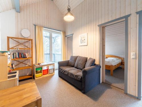 a living room with a couch and a bedroom at Komfortables Ferienhaus in Mirow in Granzow