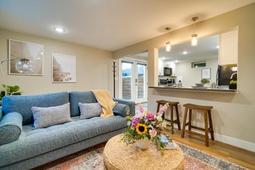 a living room with a blue couch and a table at Alluring Anchorage Apt - Walk to Coastal Trl! in Anchorage
