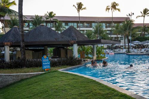 a group of people in a swimming pool at a resort at Bangalô c/ Piscina - Marulhos Resort, Beira Mar de Muro Alto / Porto de Galinhas in Porto De Galinhas