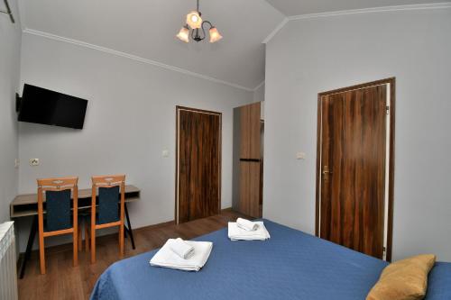 a room with two beds and a table and a desk at Apartment Mario in Martina