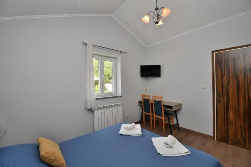 a bedroom with a bed and a table and a window at Apartment Mario in Martina