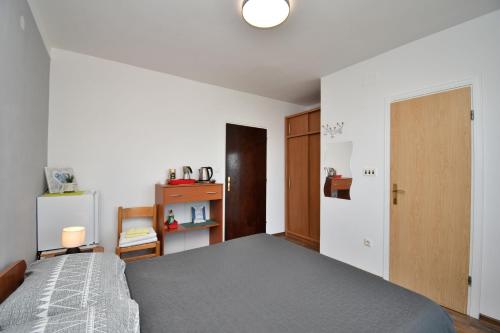 a bedroom with a large bed and a door at Apartment Mario in Martina