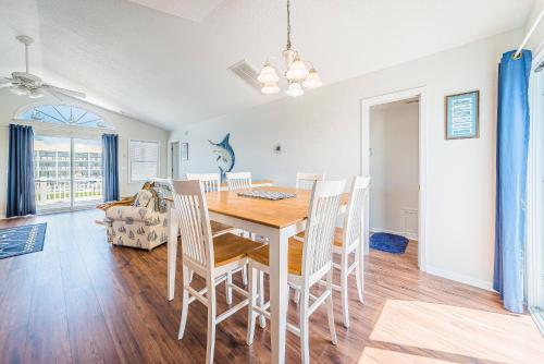 a dining room and living room with a table and chairs at Ocean View's in Kill Devil Hills