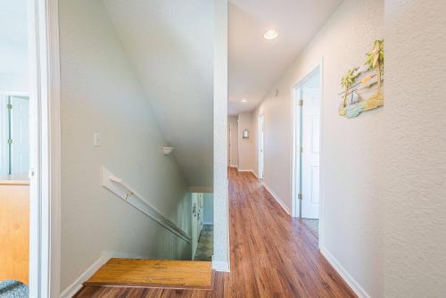 a hallway of a house with a stairwell and a room with wood floors at Ocean View's in Kill Devil Hills
