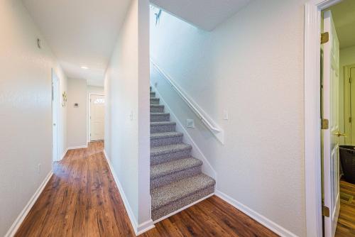 a staircase in a home with white walls and wood floors at Ocean View's in Kill Devil Hills