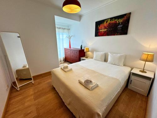 a bedroom with a bed with two towels on it at Tejo Balcony Expo in Lisbon