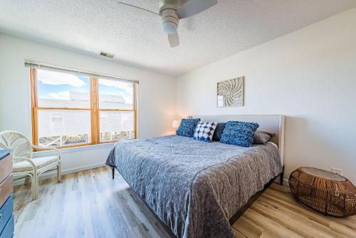 a bedroom with a bed and a window at OCTIPI Your SenSEAS in Kitty Hawk