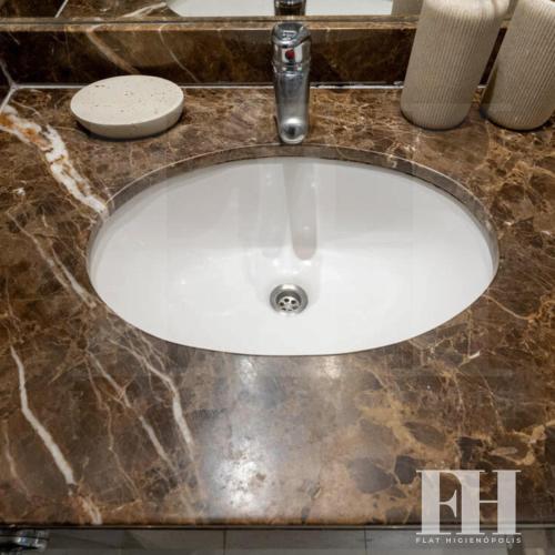 a white sink with a faucet on a counter at Flat Higienópolis Premium in Sao Paulo