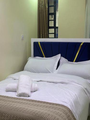 a bed with white sheets and pillows on it at Ann'sbammyline Serene homes in Ruiru