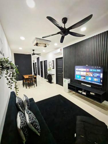 a living room with a couch and a ceiling fan at Carissa Homestay Kuantan in Kuantan