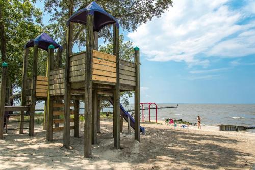 a playground on the beach next to the water at Otters Run - K1503 in Eagleton