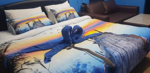 a bed with a painting of a hand on it at Koh Samed Lung Dam Hutbeach in Ao Phutsa