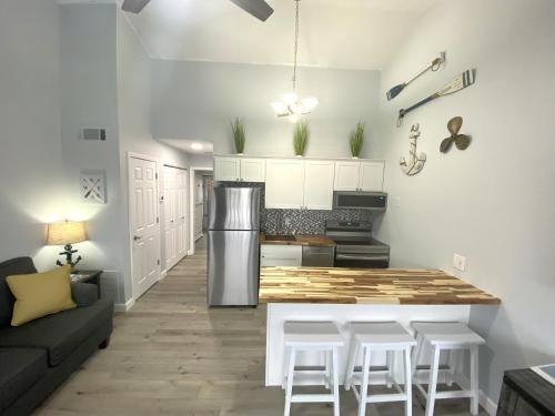 a kitchen with a table and some white cabinets at B Lakefront! Remodeled, Boat Slip, Patio Views, Pool, Boat Ramp, WIFI in Osage Beach