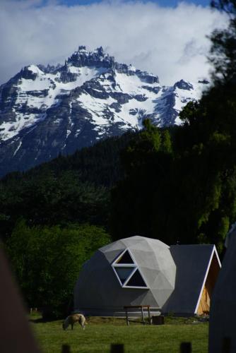 a tent in front of a snow covered mountain at Nomade Patagonia Glamping & Domos in Trevelin