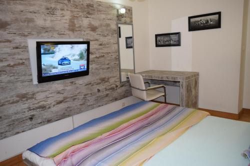 a bedroom with a bed and a tv on a wall at Vip apartment Beograd in Belgrade