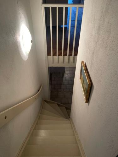 a staircase in a building with a picture on the wall at Charming Nordic Home in Central Älmhult in Älmhult
