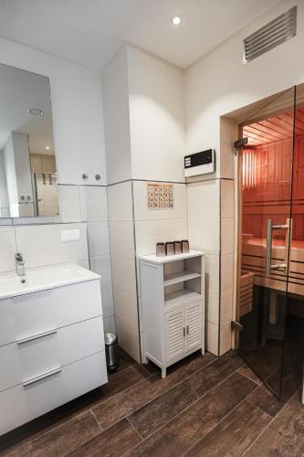 a white bathroom with a sink and a desk at Talblick 5, mit Sauna und wunderschönen Panoramablick NEU in Walkenried