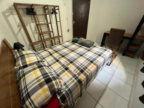 Ένα ή περισσότερα κρεβάτια σε δωμάτιο στο Quarto Aconchegante