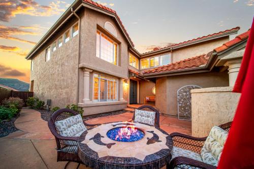 a patio with a table and chairs and a fire pit at Rancho Bernardo Home - Game Room Outdoor Living in Rancho Bernardo