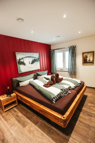 a bedroom with a large bed with a teddy bear on it at Talblick 5, mit Sauna und wunderschönen Panoramablick NEU in Walkenried