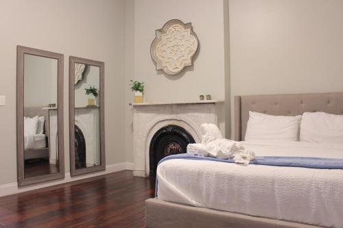 a bedroom with a bed with a fireplace and a mirror at RARE 1BR Apt with Character GREAT Location! in Albany