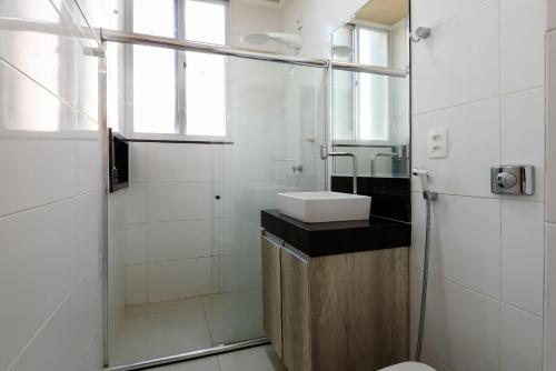 a bathroom with a sink and a glass shower at 2 Quartos em Copacabana c/ Vista-Mar | PJ 135/808 in Rio de Janeiro