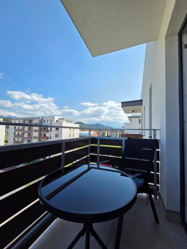 a table and a chair on a balcony at Castle View in Rasnov in Râşnov