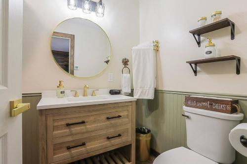 a bathroom with a sink and a mirror and a toilet at Refined 6br Moose & Bear Lodge By Sweetheart Stay in Livingston