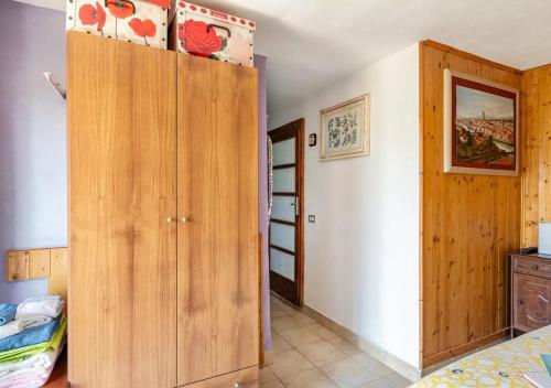 a bedroom with a large wooden cabinet in a room at Holidays with a view of Montecarlo di Lucca in Sorana