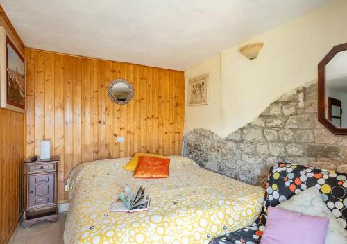 a small bedroom with a bed and a couch at Holidays with a view of Montecarlo di Lucca in Sorana