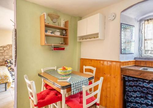a kitchen with a table and chairs and a kitchen with a sink at Holidays with a view of Montecarlo di Lucca in Sorana