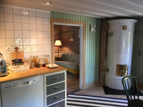 a kitchen with a sink and a stove in a room at One Room Bed & Breakfast in Skänninge