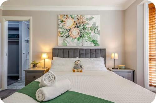 a bedroom with a bed with a teddy bear sitting on it at Tranquility in Oberon