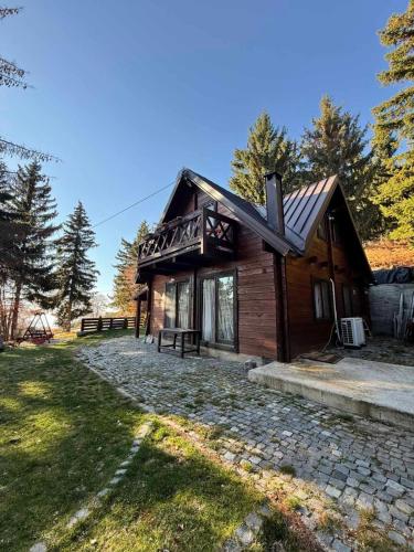 a log cabin with a stone path in front of it at The mountain house Dora in Kochani