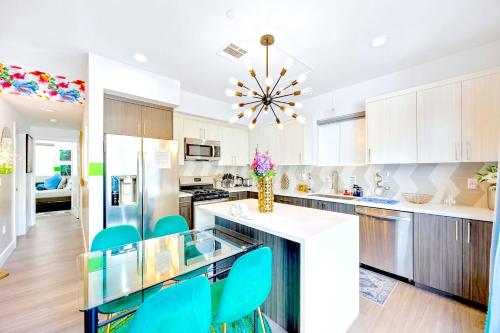 a kitchen with white cabinets and blue chairs at B - 3BR NoHo Retreat 15m to Universal with Patio, Games & Parking - FIFA World Cup SoFi in North Hollywood