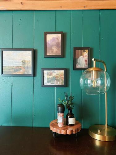 a room with a blue wall with a lamp and pictures at Cozy 1bd apartment in the heart of Liverpool NY in Liverpool