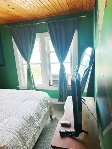 a bedroom with a bed and a tv on a table at Cozy 1bd apartment in the heart of Liverpool NY in Liverpool