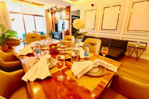 a dining room table with plates and wine glasses at Barsana - Seaside Luxury 2BDR - Panoramic Marina & Sea Views in Dubai