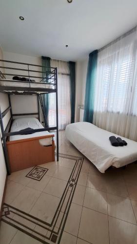 a bedroom with two bunk beds in a room at The Happy Goat Apartment in Germignaga