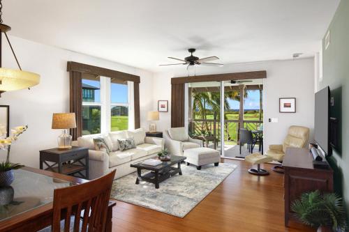 a living room with a couch and a table at Poipu Retreat with Golf Ocean Views and AC in Koloa