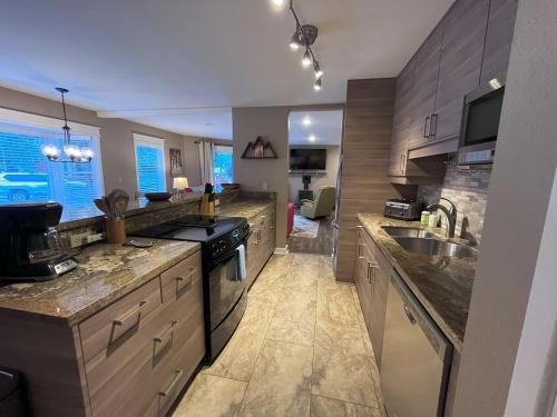 a large kitchen with a sink and a stove at Smuggler Mine - Pet-friendly family ski condo! in Telluride